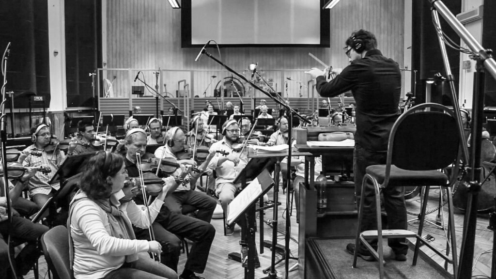 Mastering the Art of Film Music Composition: Expert tips to start your adventure 1 Film music composition sometimes requires conducting an orchestra.