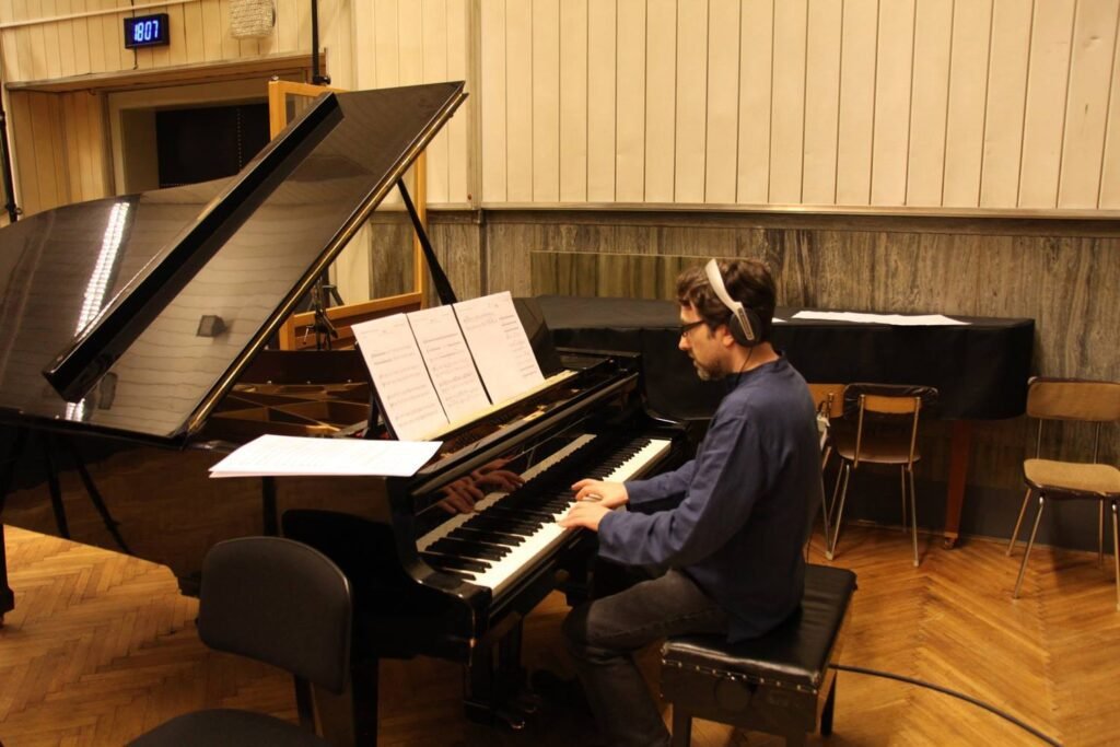 Swan Cake: The Animated Short Film that Dances its Way to Success 1 Mark Slater composing themes for Swan Cake at the piano